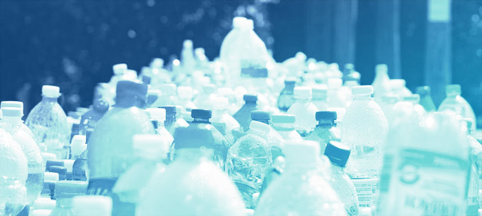 plastic bottles lined up for recycling, with blue overlay